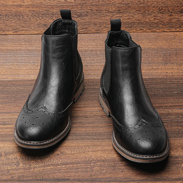Durable men's Chelsea boots in rich leather, featuring a classic slip-on design for easy wear.