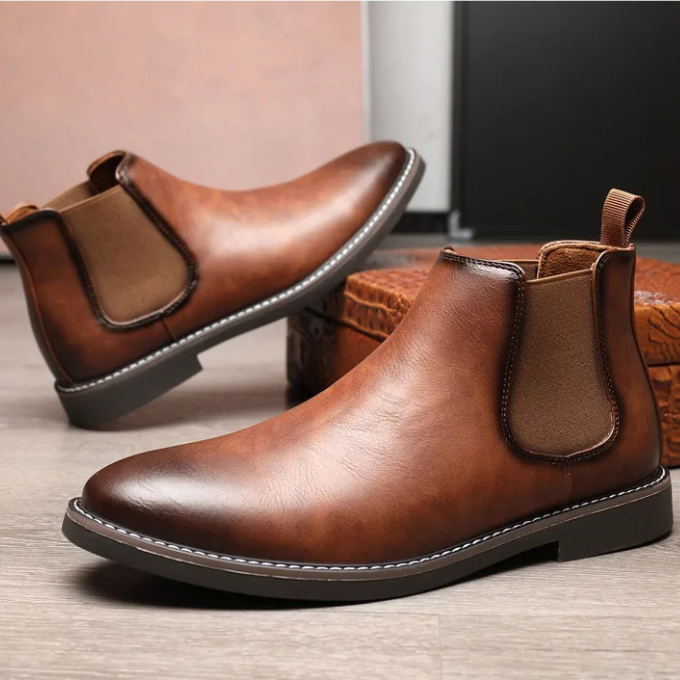 Top-down view of men's classic brown leather Chelsea boot pair, elegant footwear.