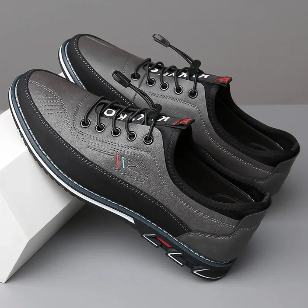 Detailed view of men's sleek black Oxford dress shoes. Premium leather, comfortable fit for business & formal wear.