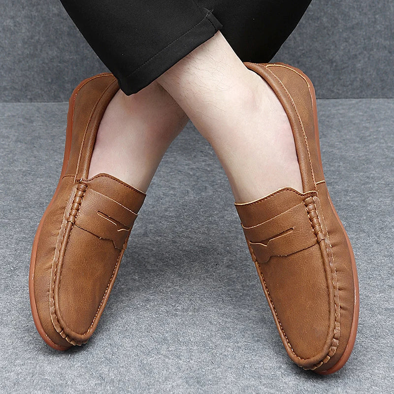 Stylish men's black leather penny loafers, a versatile slip-on shoe.