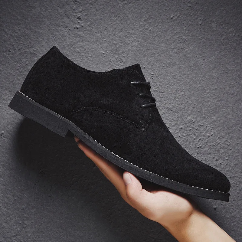 Lace-up detail on men's tan suede Oxford dress shoes, showcasing the quality and classic style.