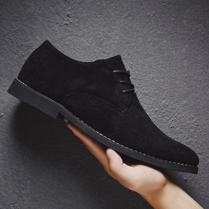 Lace-up detail on men's tan suede Oxford dress shoes, showcasing the quality and classic style.