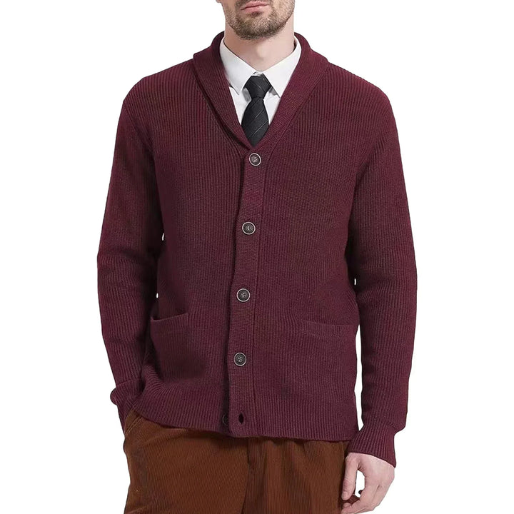Stylish men's winter wear: a button-front cable knit cardigan draped over a chair, ready for layering.