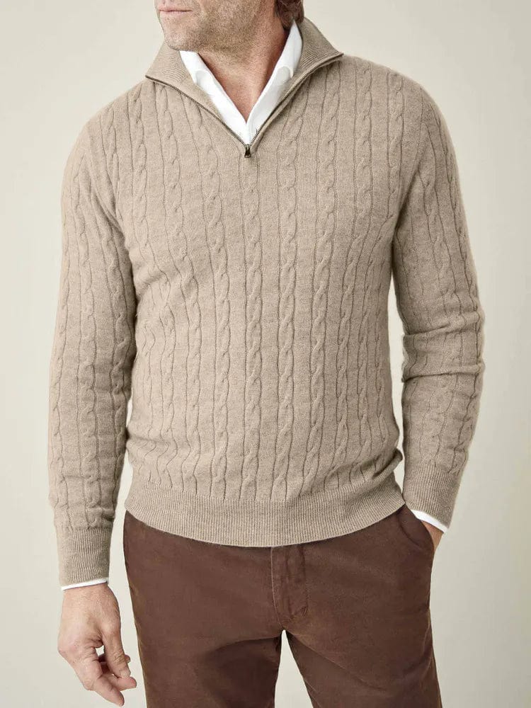 Close-up detail of men's cable knit half-zip jumper. Features classic texture, stand collar, and rib trim.