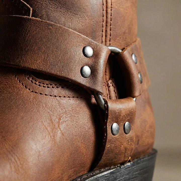 Close-up of classic men's cowboy boots with detailed studded strap, showcasing premium western design.
