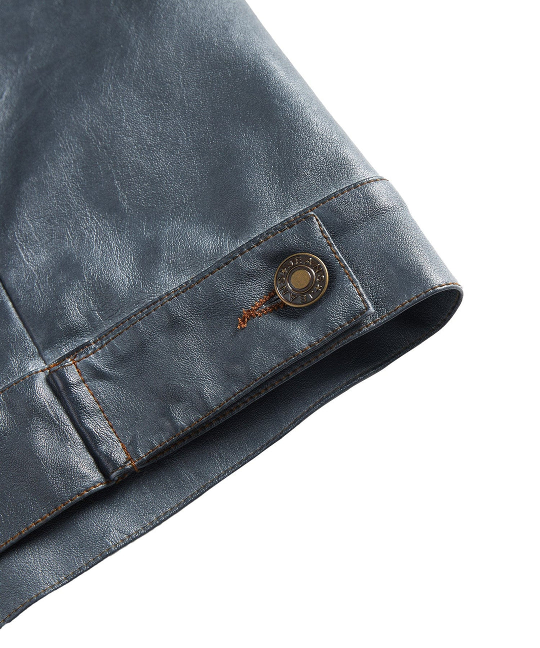 Close-up of the collar and lapel on a men's black faux leather biker jacket, detailing the classic cut