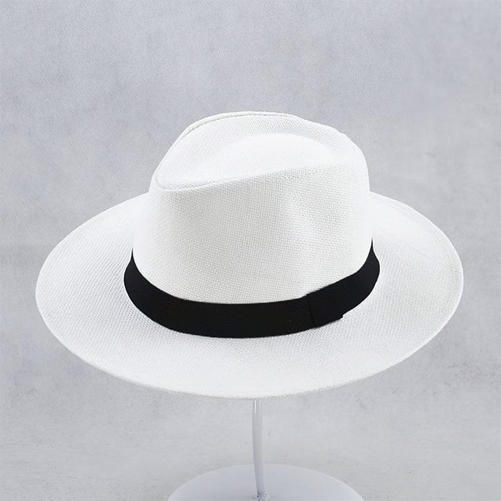 Close-up of a handmade men's Panama hat, showcasing natural straw texture & classic black band.