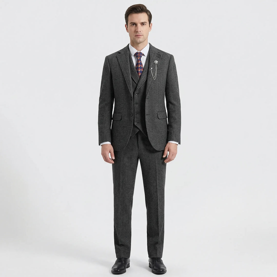 Close-up of elegant men's gray herringbone fabric on a 3-piece suit, showcasing the classic weave & quality.