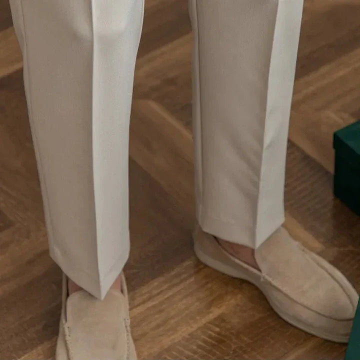 Dynamic pose of model wearing men's straight leg dress pants, emphasizing freedom of movement