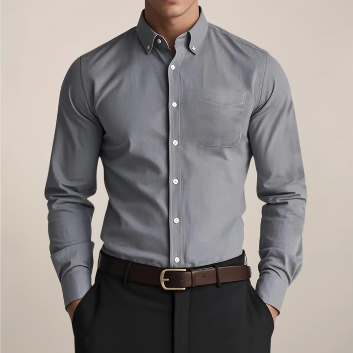 Close-up of a men's classic long sleeve button-up shirt, showing detailed fabric texture and elegant buttons. Smart casual men's wear.
