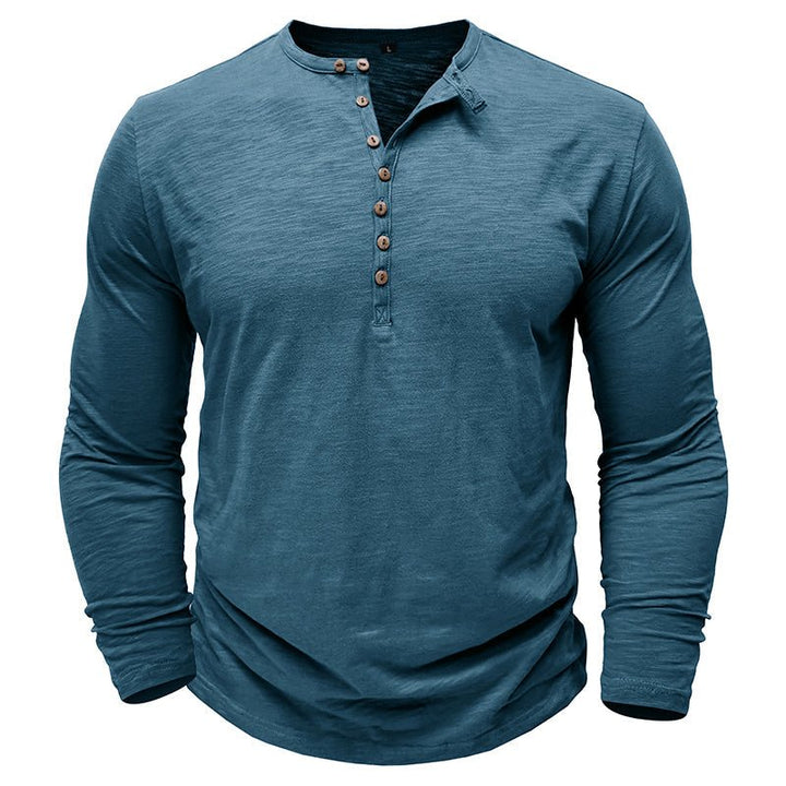 Man walking outdoors in a comfortable long-sleeve henley shirt, showcasing casual fashion & movement