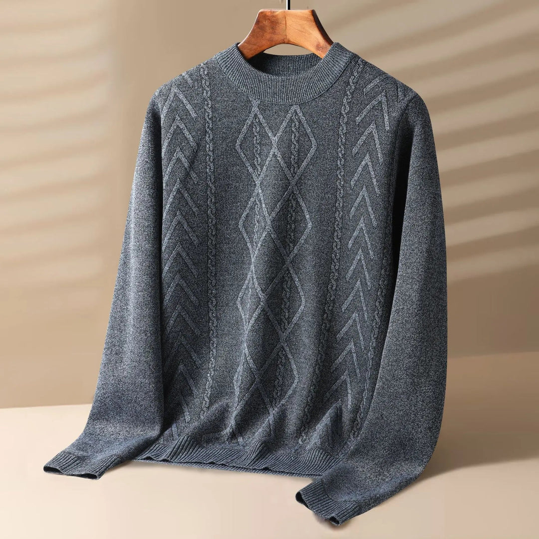 Man wearing a warm, cream-colored cable knit crewneck sweater, ideal for layered winter outfits.