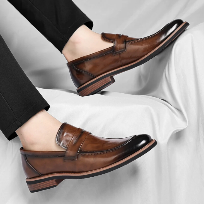 Men's polished leather penny loafers in a rich burgundy, a versatile addition to any wardrobe