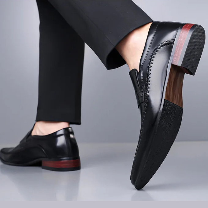 A man wearing classic polished leather dress shoes, demonstrating their sharp formal look.