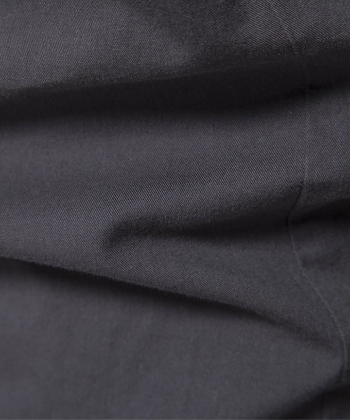 Close-up of the stitching and finishing on a men's premium cotton blend casual shirt.