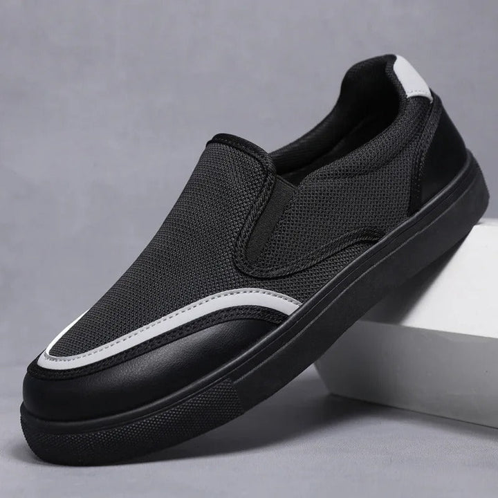 Stylish black men's slip-on loafers, versatile for casual or dress occasions.