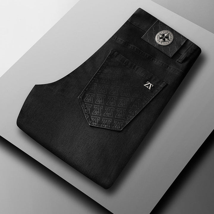 Close-up of the textured fabric of men's classic straight-fit stretch denim jeans, highlighting quality.
