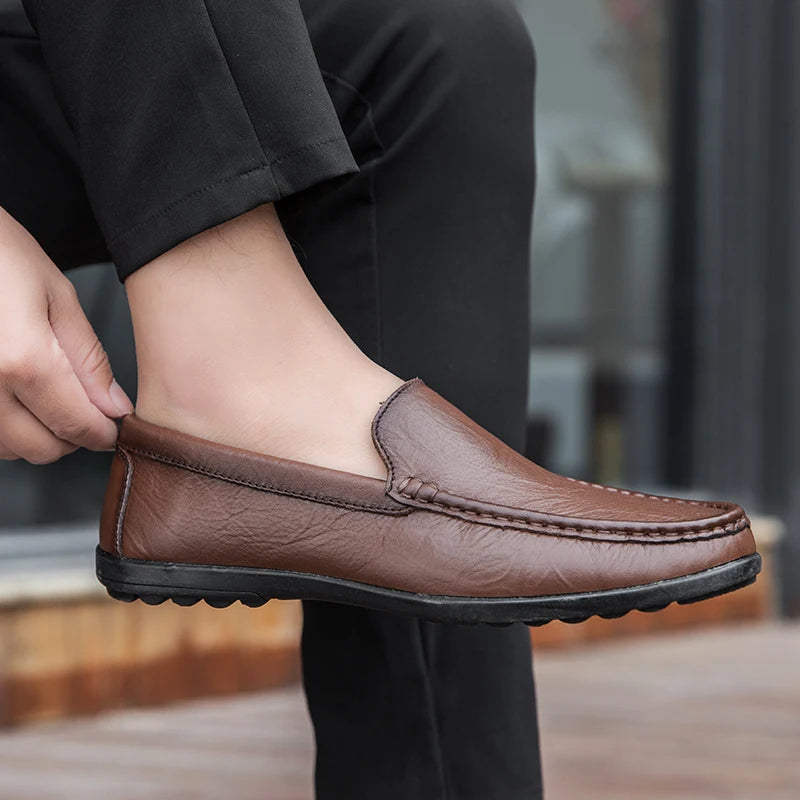 Front view of men's polished black leather slip-on loafers, a staple in men's business casual.