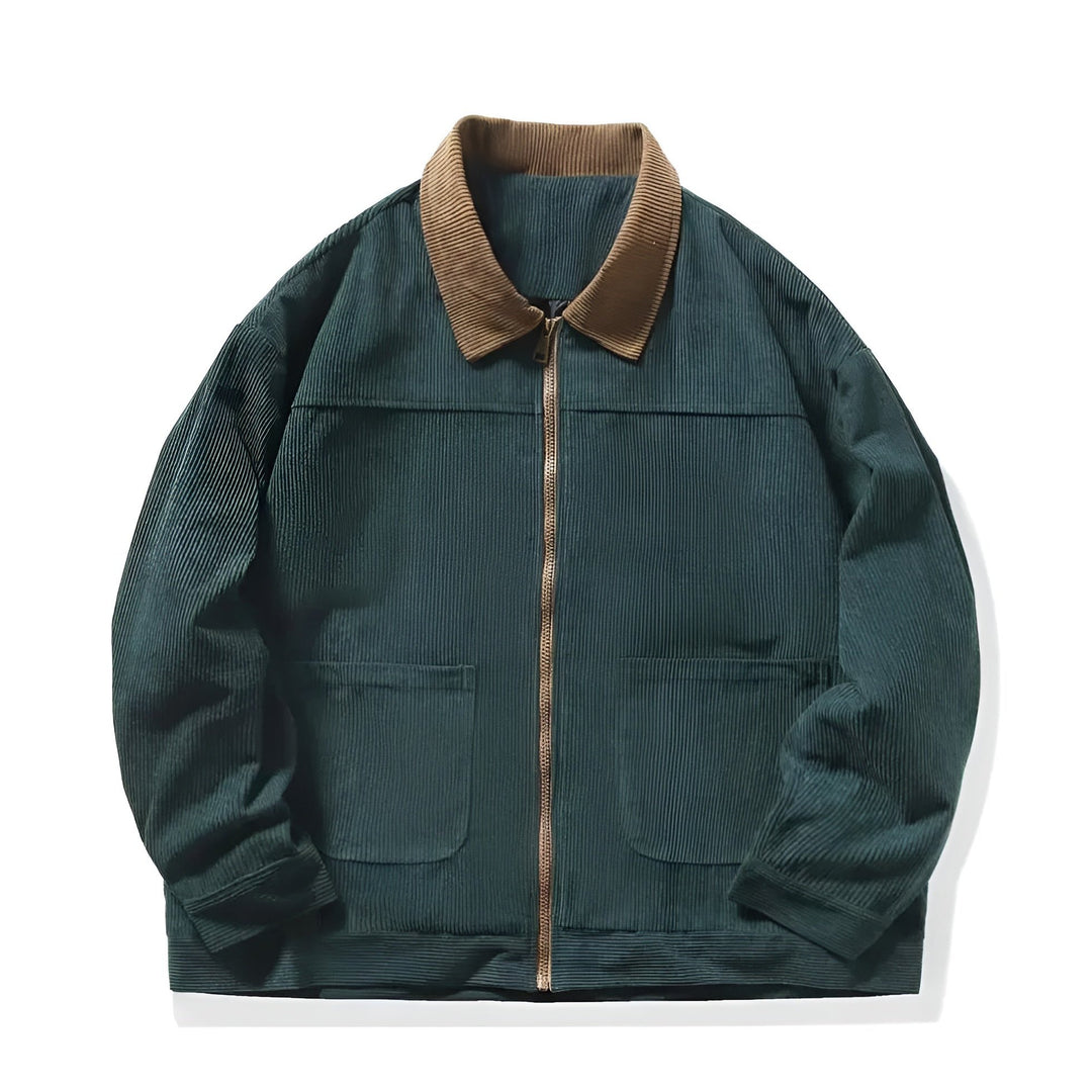 Close-up of the textured corduroy fabric on a men's zip-up jacket, highlighting its fall fashion appeal.