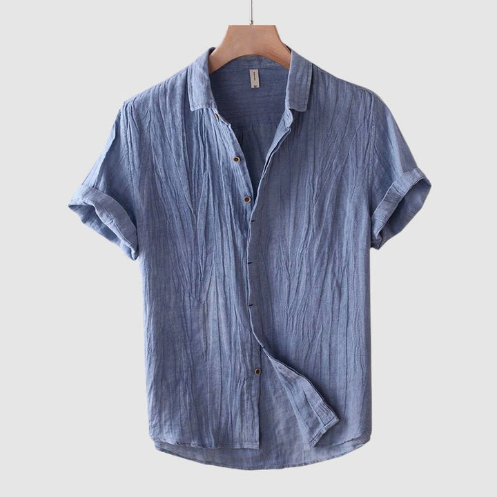 Modern men's button-down crinkle shirt, short sleeves, versatile for warm weather.