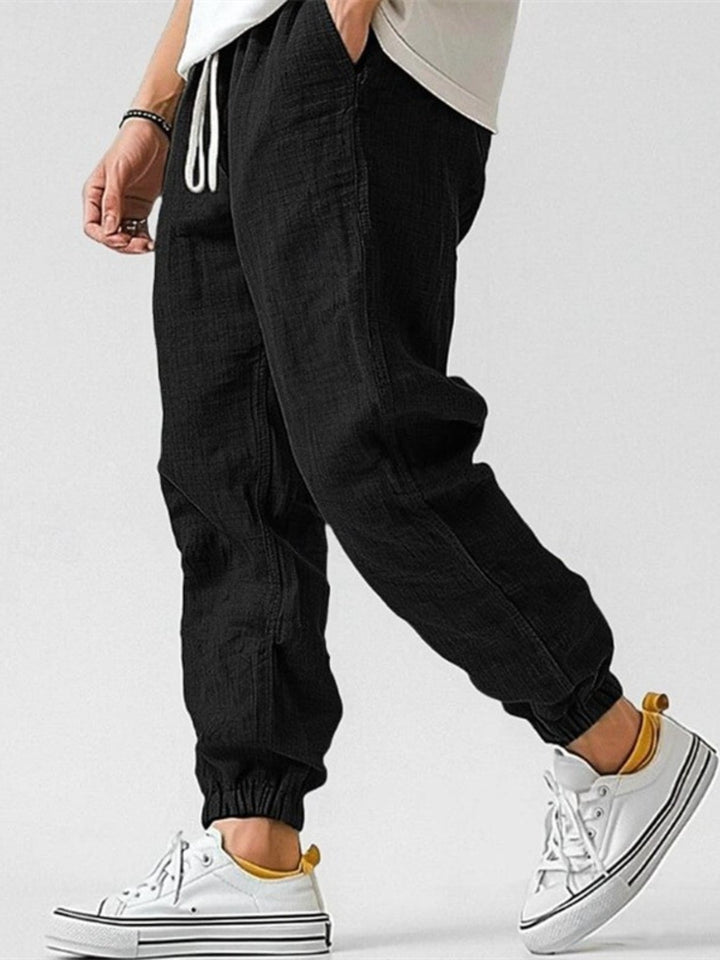 Stylish men's streetwear joggers with a cuffed hem and relaxed fit. Modern casual pants for men.
