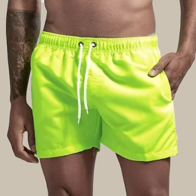 Quick-dry men's swim shorts, perfect for beach, pool & summer vacation; comfortable drawstring waist.