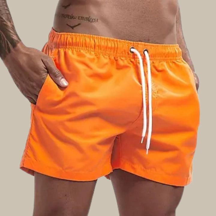 Stylish men's beach shorts with drawstring waist; quick dry swimwear for pool & summer fashion.