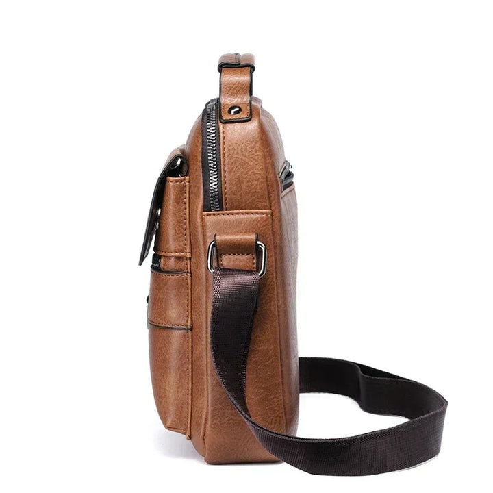 Man wearing a black durable crossbody bag, ideal for daily essentials, work, or travel. Adjustable shoulder strap.