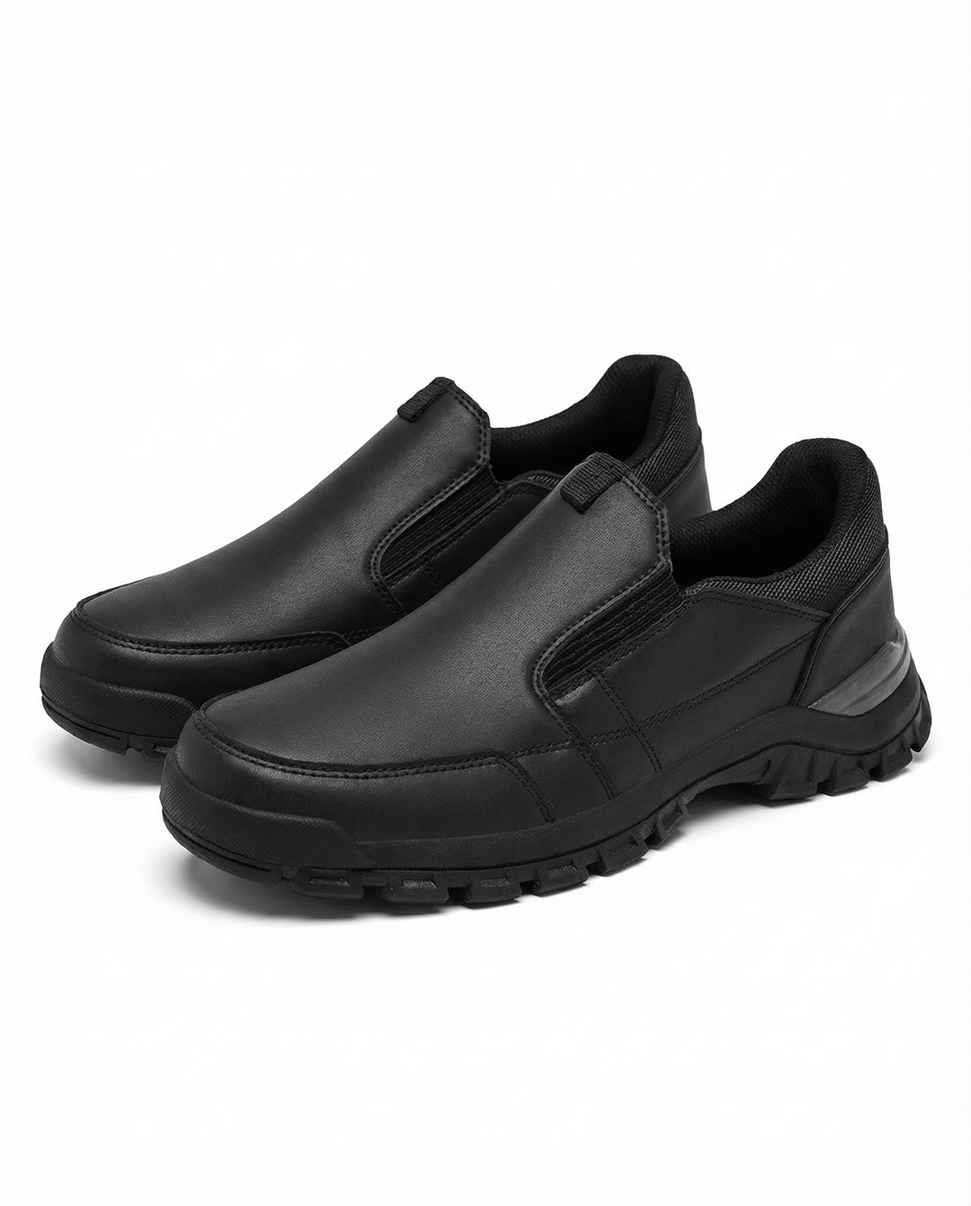 Men's fashionable leather slip-on shoes on a wooden floor, emphasizing quality and ease.