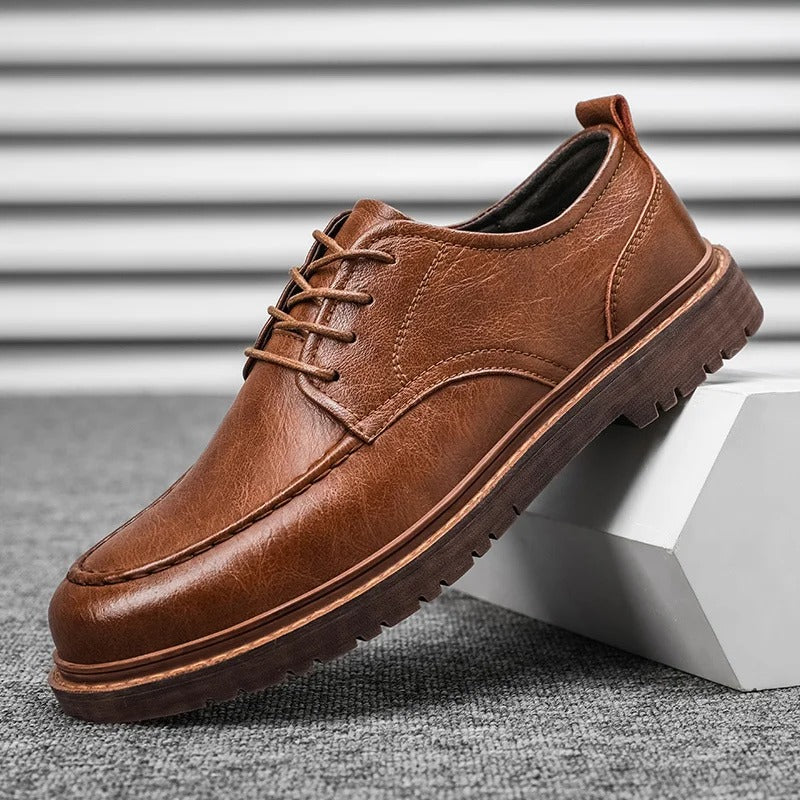 Side profile of a men's durable brown leather loafer, showcasing the sole and comfortable fit.