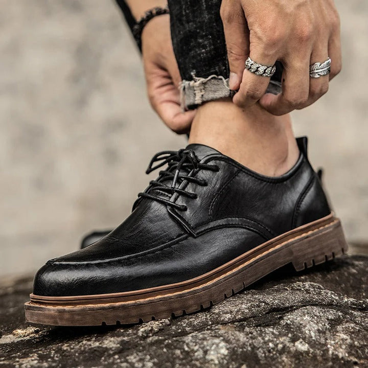 Top-down view of men's durable brown leather loafers, perfect for a polished casual look.