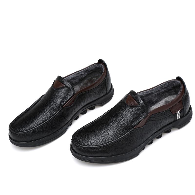 Men's black faux leather slip-on loafers on a white background, studio shot.
