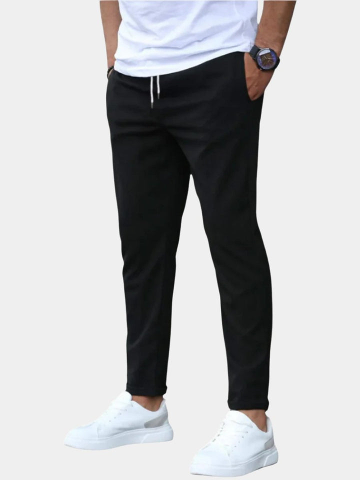 Men's flexible slim-fit chino pants with drawstring, ideal for versatile casual wear.
