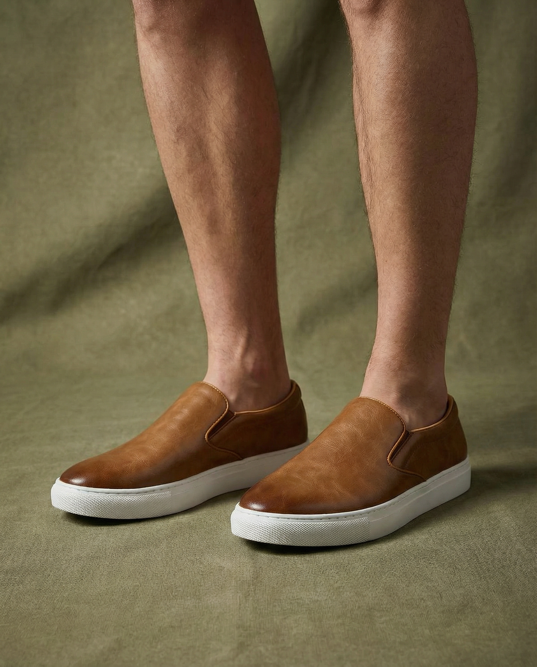 Pair of men's black leather slip-on shoes, perfect for versatile casual wear and long-lasting comfort.