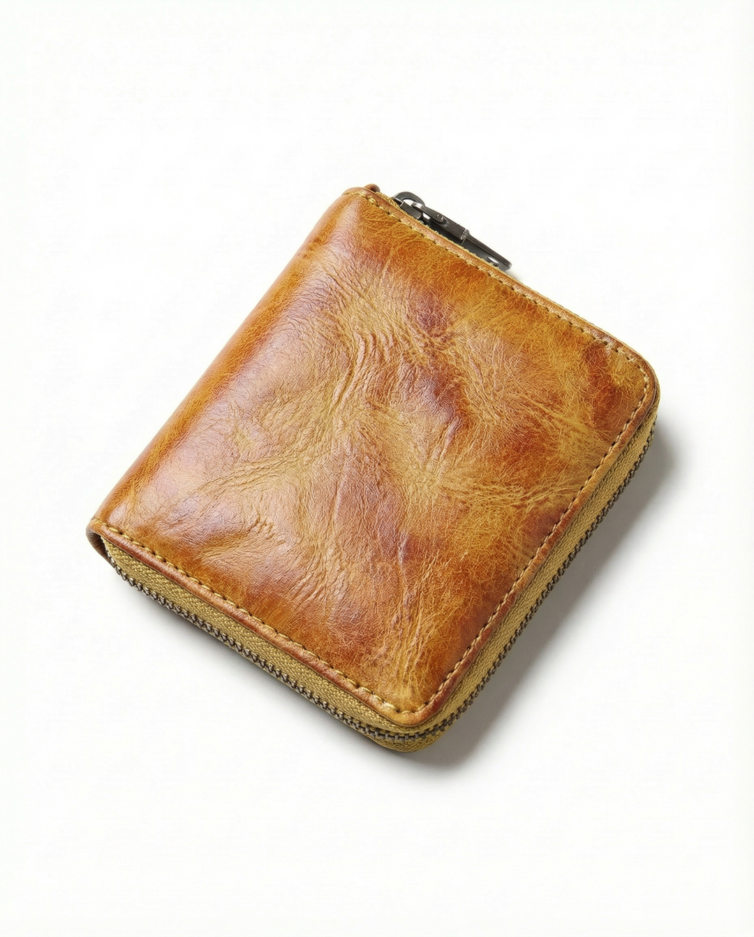 Men's leather zip wallet in hand, showcasing its compact size