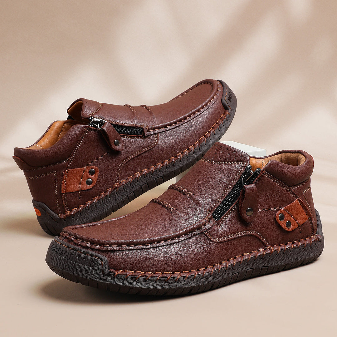 Pair of comfortable men's high-top leather ankle boots, showcasing the rich, durable leather texture.