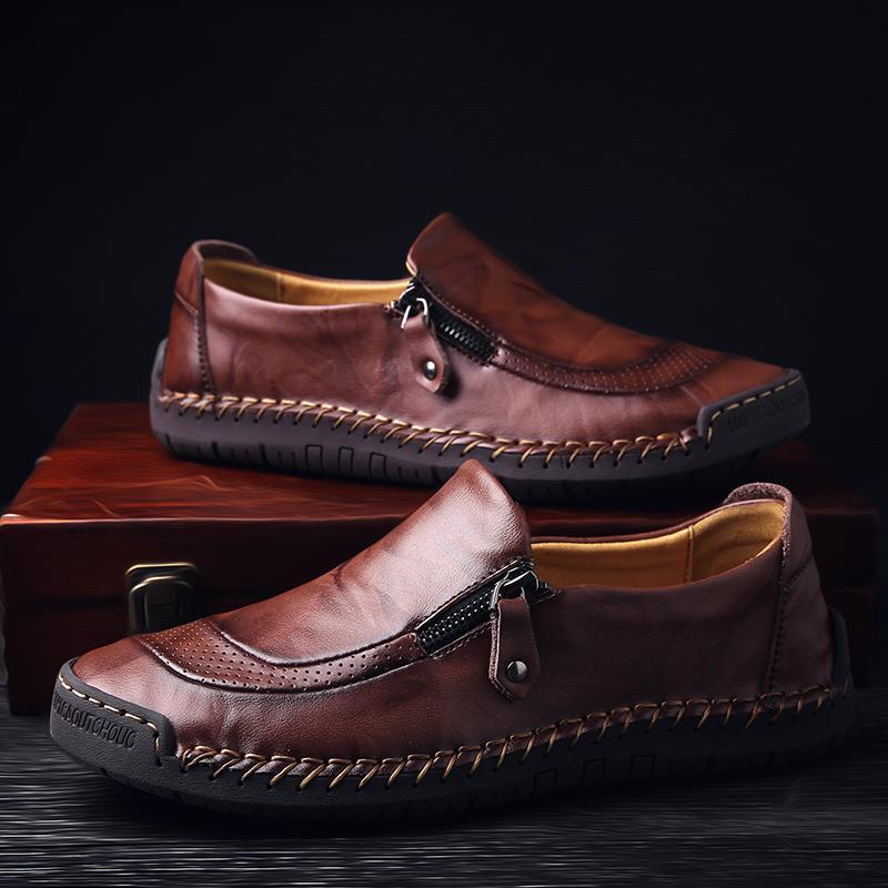 Top-down view of men's black leather loafers, slip-on, hand-stitched, unique zipper design