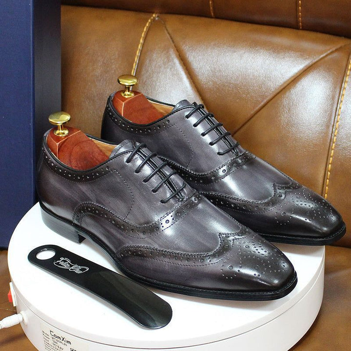 Classic men's handcrafted Oxford dress shoes with intricate wingtip brogue detailing, ideal for formal events.
