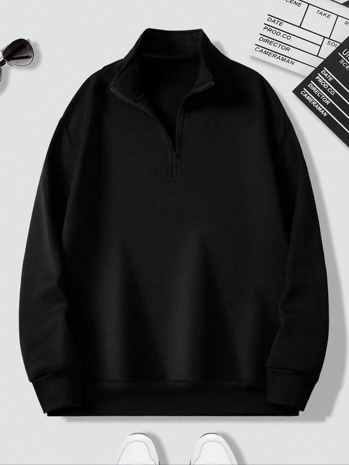 Man wearing a black long-sleeve half-zip fleece crewneck sweatshirt, perfect for everyday wear