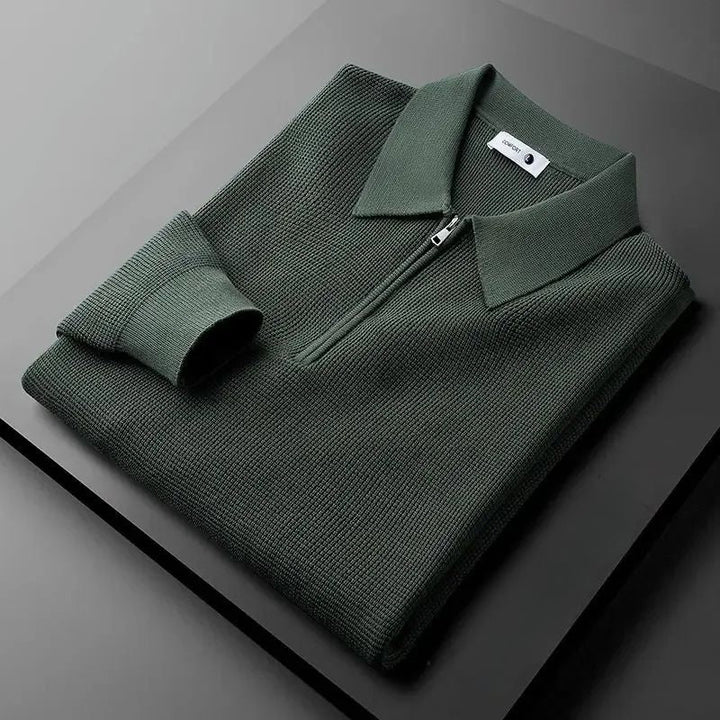 Close-up of men's navy blue zip polo sweater, fine cotton knit texture, versatile top