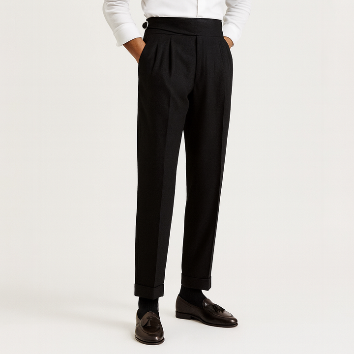 Tailored men's high-waisted pants with crisp pleats and cuffed hem, offering a sophisticated look for fashion.