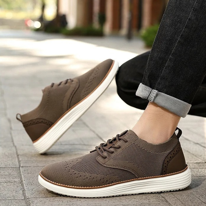 Front view of men's hybrid dress sneakers, highlighting the detailed wingtip and durable laces.