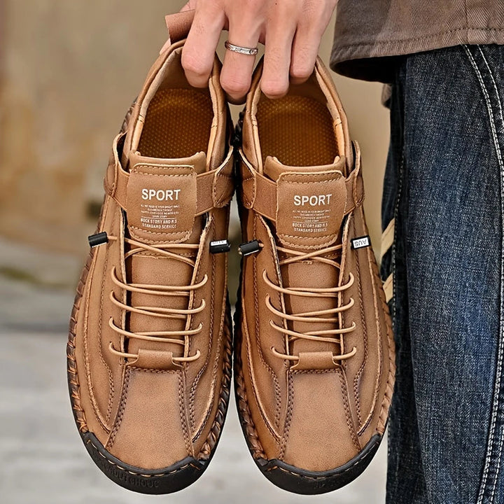 Mens black leather orthopedic sneakers on a neutral background, highlighting their versatile style.