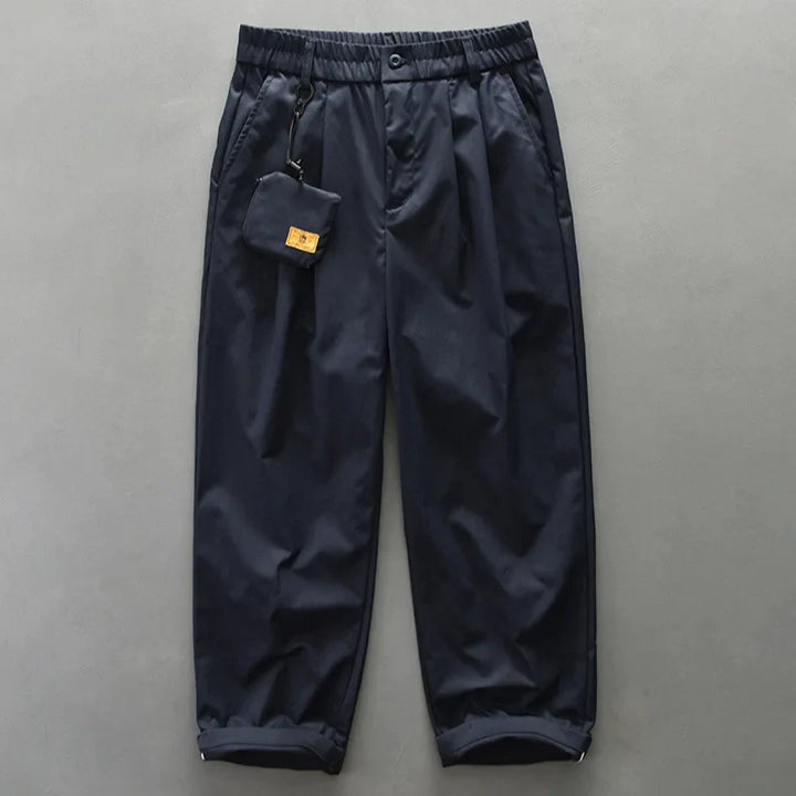 Close-up of men's utility pants fabric, highlighting lightweight and water-resistant features for travel