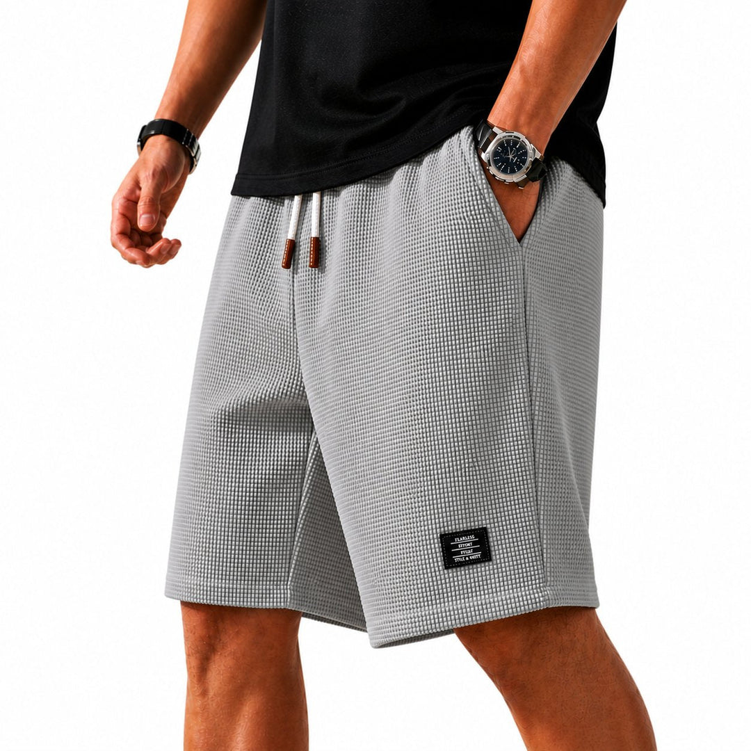 Casual men's lightweight waffle shorts featuring an elastic drawstring waist for summer comfort.