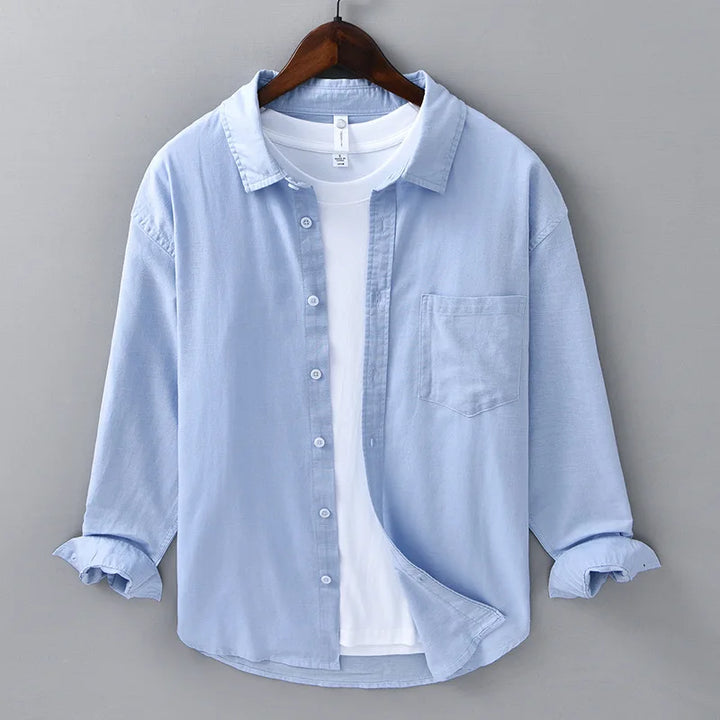 Close-up of a men's blue linen button-up shirt, breathable for beach style