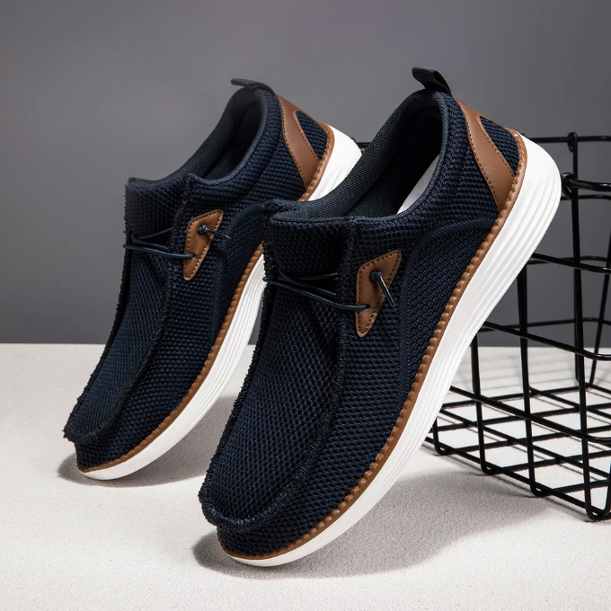 Stack of men's woven slip-on loafers in different colors, showcasing variety