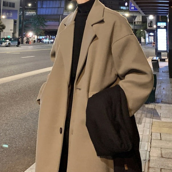 Tailored men's long overcoat with belt, ideal for a sophisticated formal or smart casual autumn look.