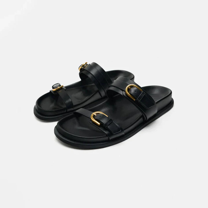 Close-up of men's leather slide sandal showing stitching and premium material