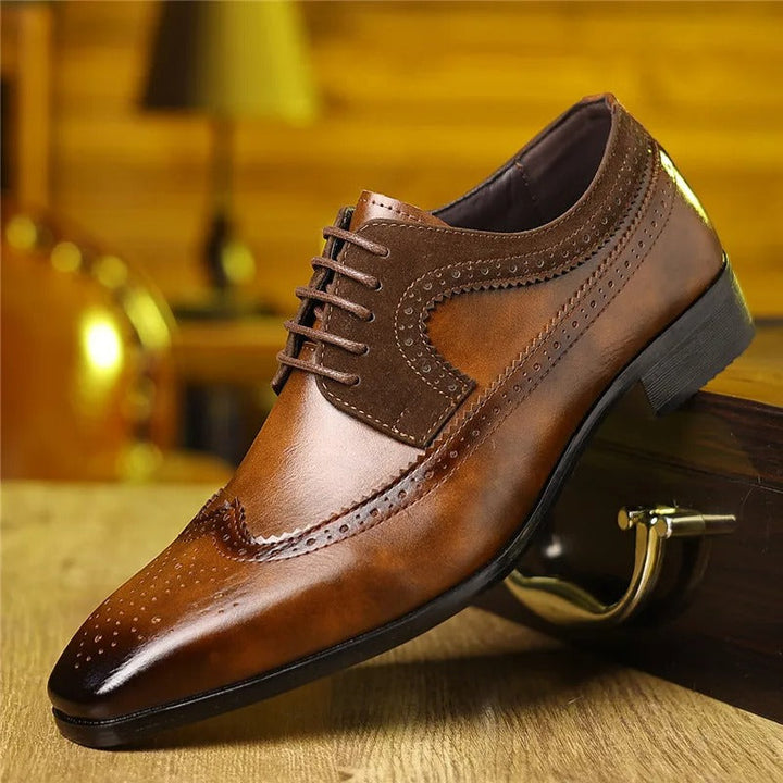Close-up of elegant men's leather Oxford shoes featuring intricate brogue detailing for weddings.